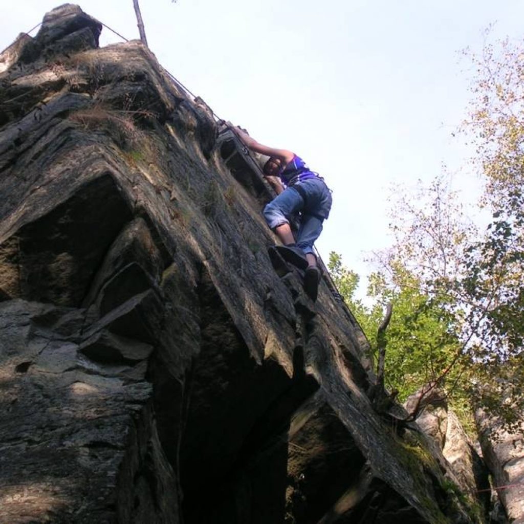 Person klettert Felsen hinauf